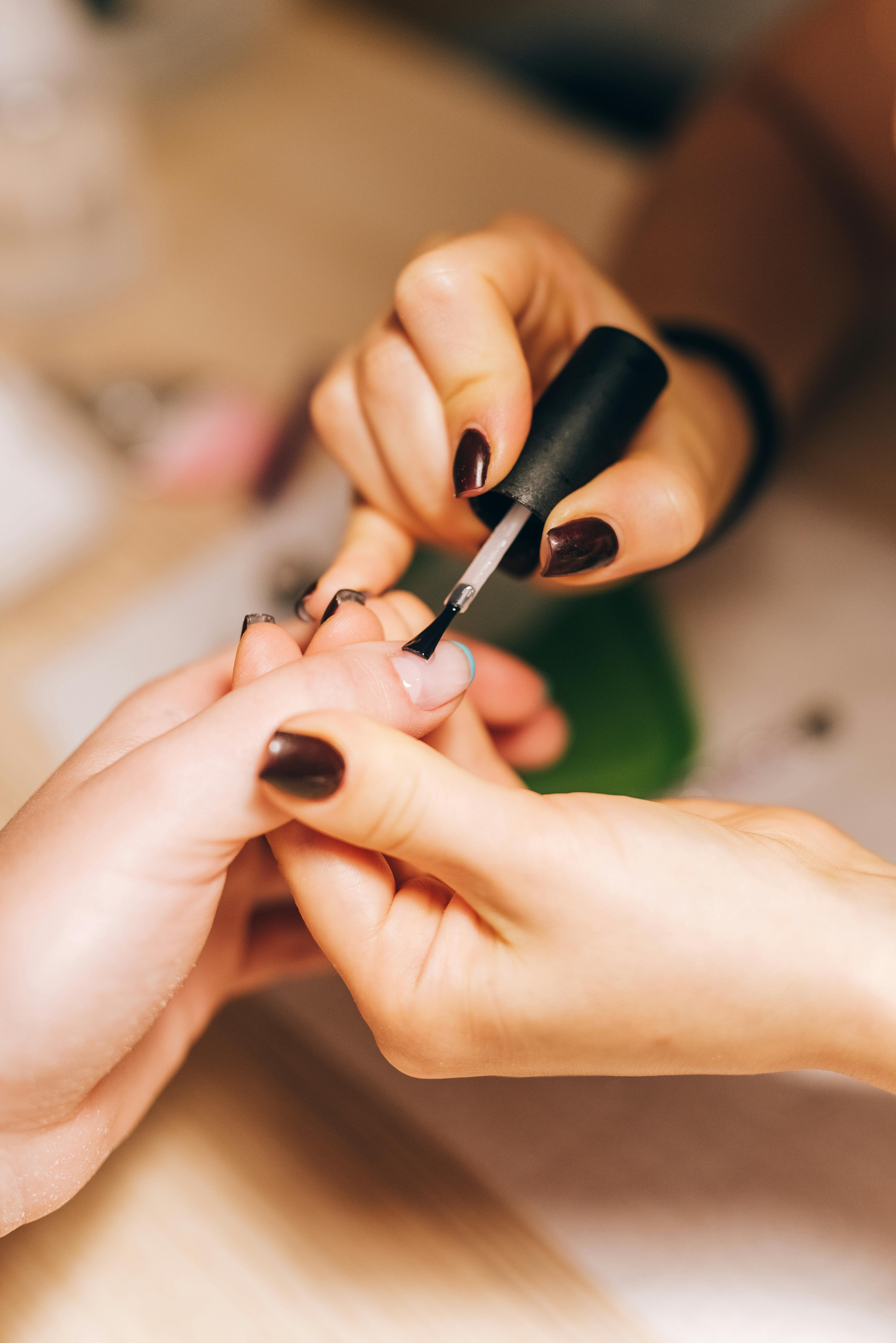 Real manicure polish application close up